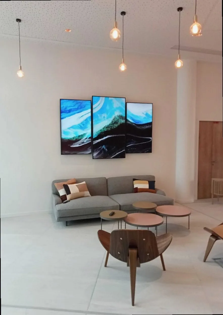 Stylish living room featuring digital art display and modern furniture decor.